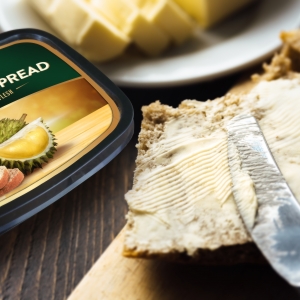 A knife spreading butter on bread